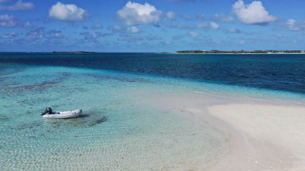 Inflatable dinghy anchored by island in Bahamas